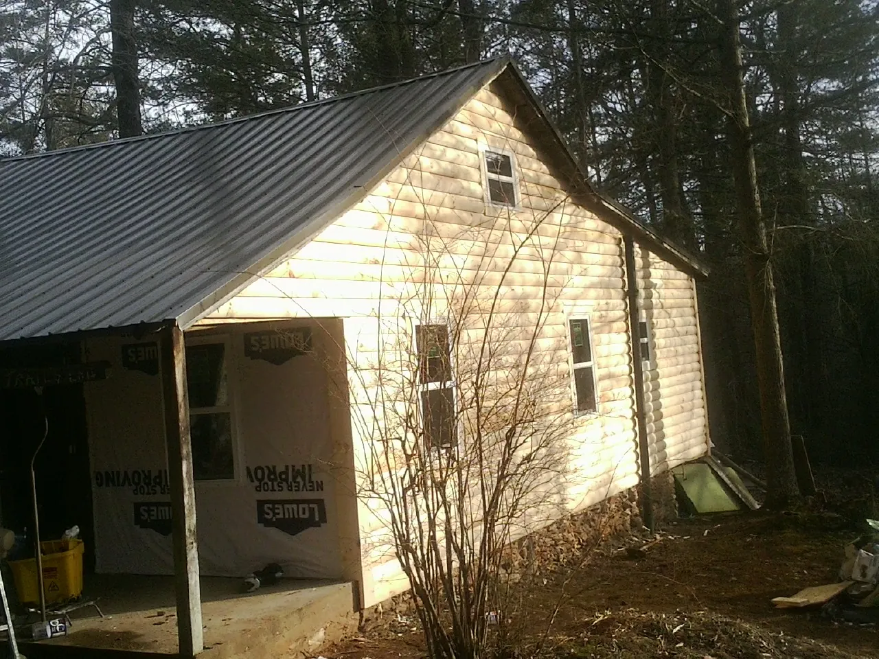Log siding gable end under a dark metal roof edge in Oxon Hill